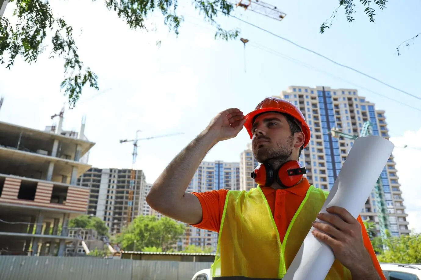 Young male civil engineer wearing a safety helmet.